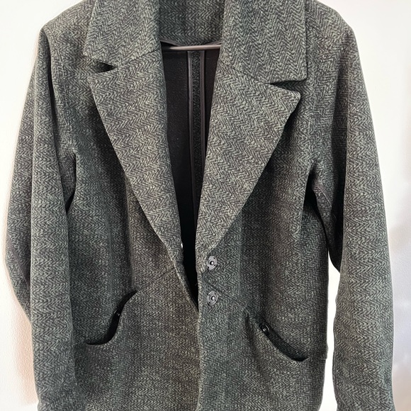 This is a lululemon cocoon coat in the color green with specs of black. - Picture 6 of 7